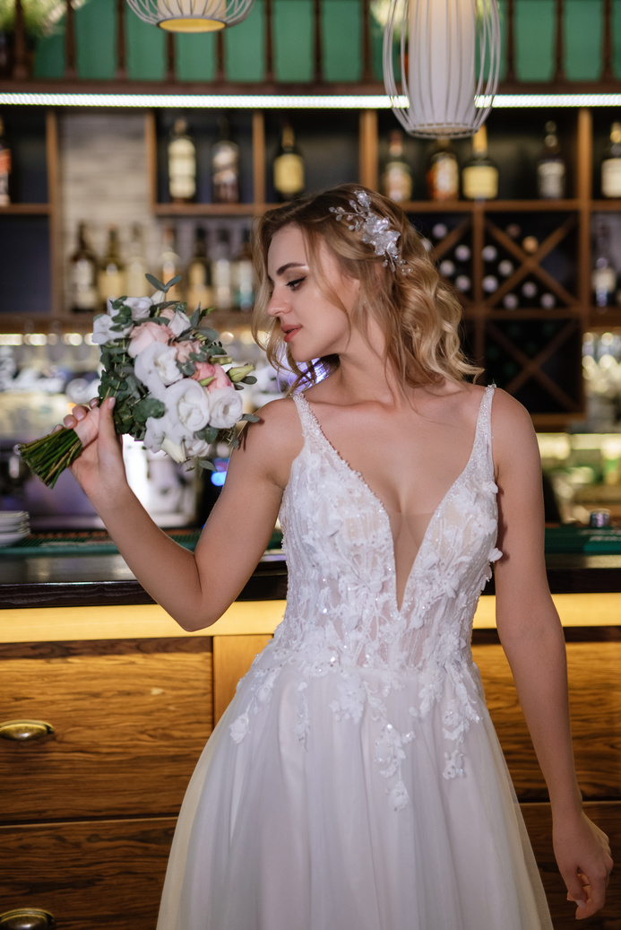blonde bride in a bar near with a wedding bouquet